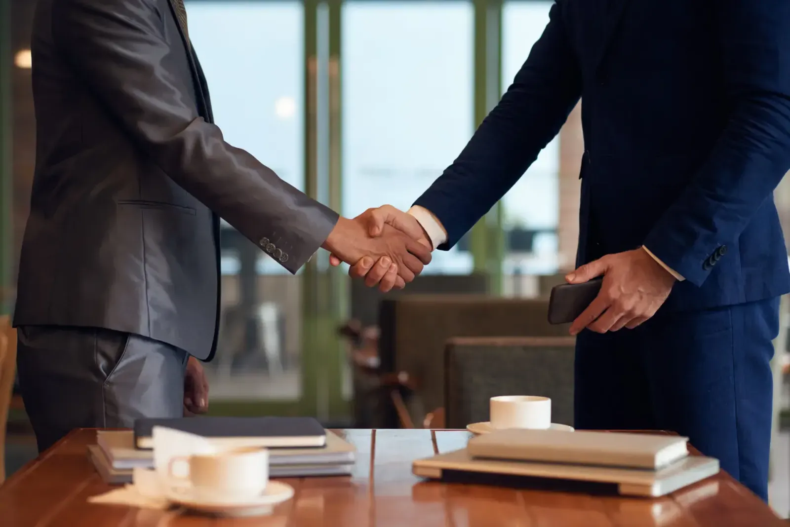 Two businessmen shaking hands to finalize a lease agreement