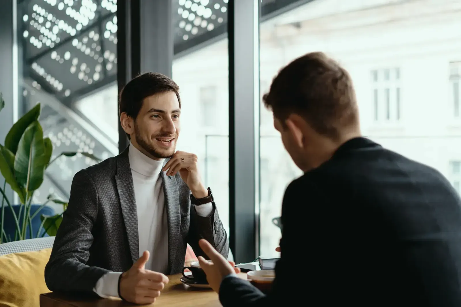 Two businessmen reviewing office lease documents together